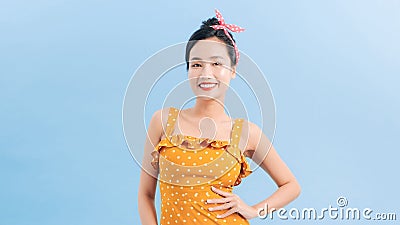 Cheerful Retro Woman in Polka Dots Rockabilly Dress. Woman wearing vintage dress with sassy attitude Stock Photo