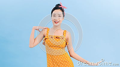 Cheerful Retro Woman in Polka Dots Rockabilly Dress. Woman wearing vintage dress with sassy attitude Stock Photo