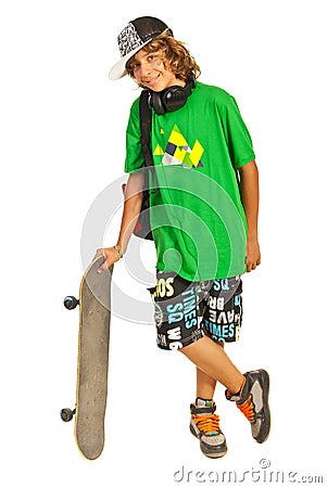 Cheerful schoolboy teen with skateboard Stock Photo