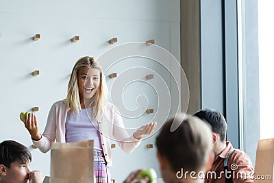 cheerful schoolgirl gesturing while talking to Stock Photo