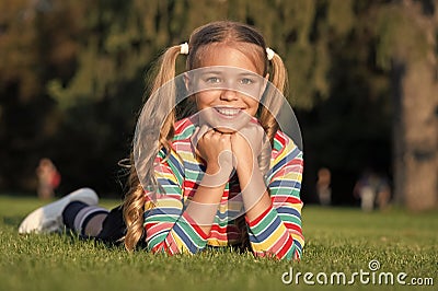 Cheerful schoolgirl on sunny day. Girl ponytails hairstyle enjoy relax. Living happy life. Happy smiling pupil. Have fun Stock Photo