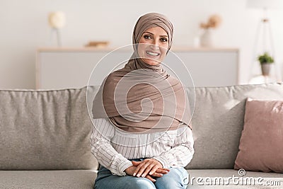 Cheerful Senior Islamic Female Posing Smiling To Camera At Home Stock Photo