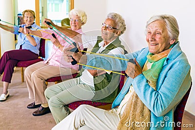 Cheerful senior women exercising their arms Stock Photo