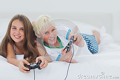 Cheerful siblings playing video games Stock Photo