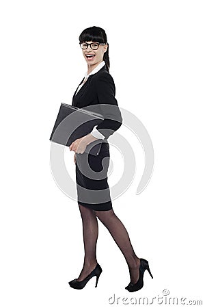 Cheerful smart business lady walking with files Stock Photo