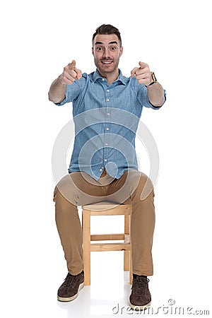 Cheerful smart casual man pointing forward with both hands Stock Photo