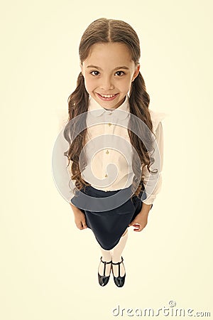 Cheerful smile. Girl cute pupil on white background. School uniform. Back to school. Student little kid adores school Stock Photo