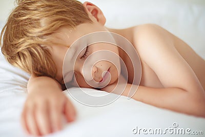 Cheerful boy sleep in bed. Stock Photo