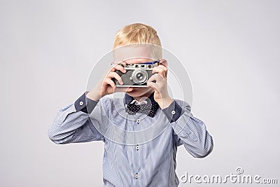 Cheerful smiling child boy holding a instant camera Stock Photo