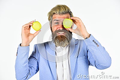 Cheerful smiling man with apples. Harvesting business. Apple became symbol for knowledge. Vitamin and diet. Fruit Stock Photo