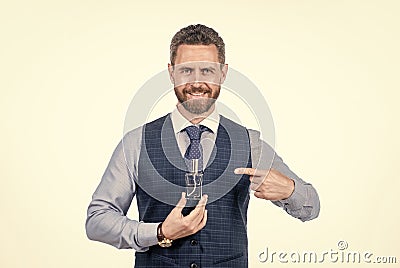 cheerful smiling man pointing finger on male perfume bottle, cologne Stock Photo