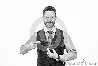 cheerful smiling man pointing finger on male perfume bottle, cologne Stock Photo