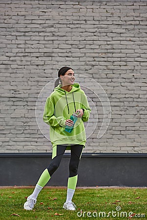 cheerful sportswoman in hoodie and leggings Stock Photo