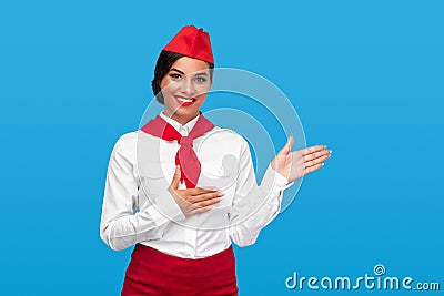 Cheerful stewardess gesturing aside during work Stock Photo