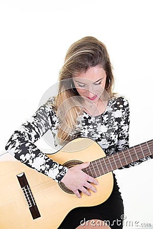 Cheerful stylish blonde woman playing learning guitar Stock Photo