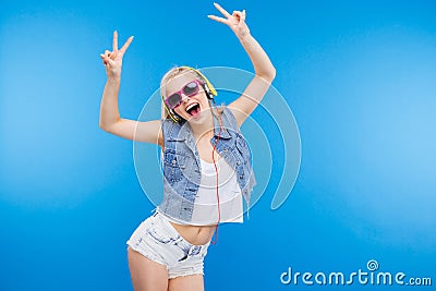 Cheerful stylish woman showing peace sign Stock Photo