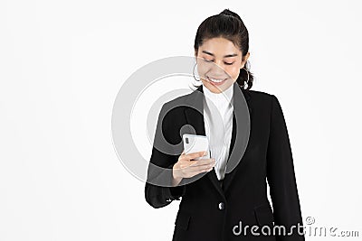 Cheerful success young Asian business woman holding mobile smart phone over white isolated background. Social network , Thinking Stock Photo