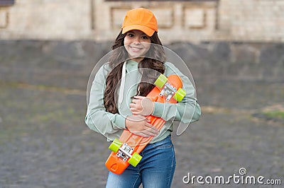 cheerful teen child skater with skateboard. girl with penny board. hipster girl with longboard skate Stock Photo