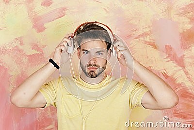 Cheerful teenage boy listening songs via earphones. Musical lifestyle. Stock Photo