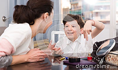 Cheerful boy telling story to mother Stock Photo