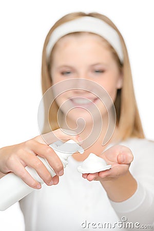 Cheerful teenager girl using cleaning foam cream Stock Photo