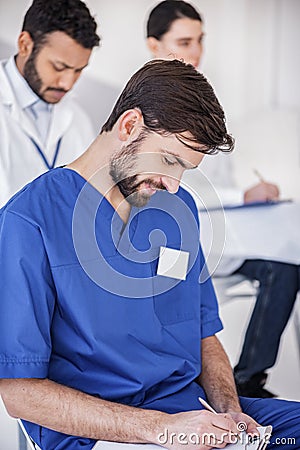 Cheerful therapeutic writing at conference in clinic Stock Photo