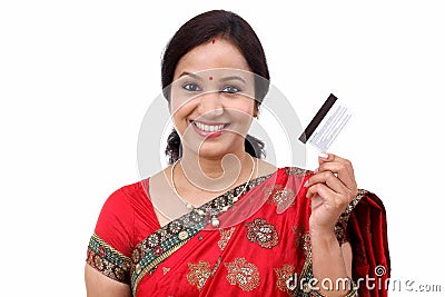 Cheerful traditional Indian woman holding a credit card Stock Photo