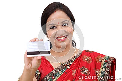 Cheerful traditional Indian woman holding a credit card Stock Photo