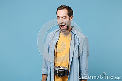 Cheerful traveler tourist man in yellow summer casual clothes with photo camera on neck isolated on blue background Stock Photo