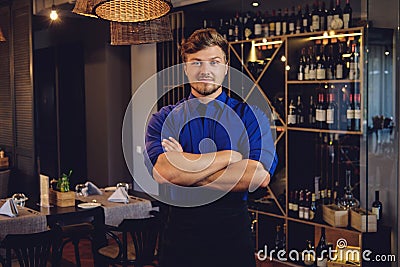 Cheerful waiter in modern restaurant Stock Photo