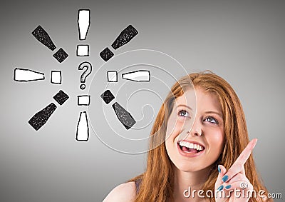 Cheerful woman with exclamation mark and question mark on grey background Stock Photo