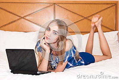 Cheerful woman with happy smile lying on the bed w Stock Photo