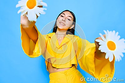 woman model young positive happiness yellow smile portrait flower chamomile blue Stock Photo