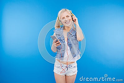 Cheerful woman listening music in headset Stock Photo