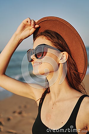 cheerful woman in sunglasses Sandy coast landscape sun Stock Photo