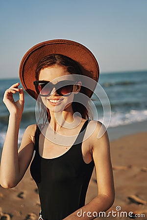 cheerful woman in sunglasses Sandy coast landscape sun Stock Photo