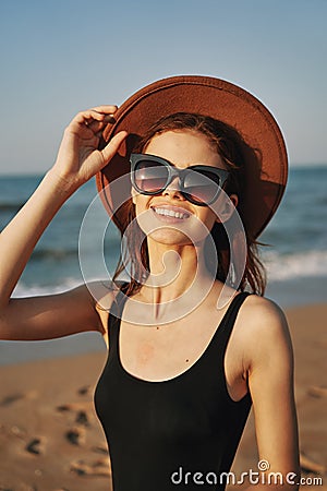 cheerful woman in sunglasses Sandy coast landscape sun Stock Photo