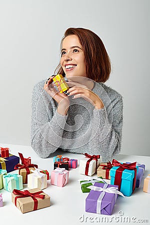cheerful woman in sweater fantasizing and Stock Photo