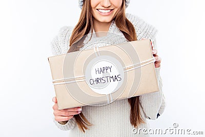 Cheerful woman in warm hat and scarf holding package and congratulate with xmas Stock Photo
