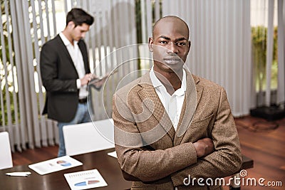 Cheerful young African man in formalwear keeping arms crossed Stock Photo