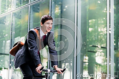 Cheerful young employee riding an utility bicycle in Berlin Stock Photo