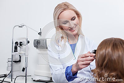 Cheerful young oculist is working with her patient Stock Photo