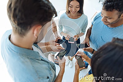 Cheerful young people using their smartphones Stock Photo