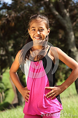 Cheerful young school girl standing in the park Stock Photo