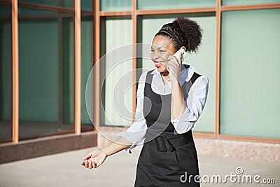 Cheerful young woman in formals using mobile phone Stock Photo