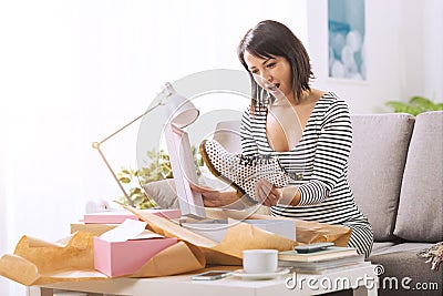 Cheerful woman opening a parcel Stock Photo