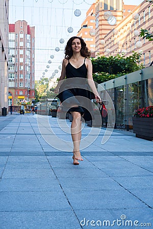 Cheerful young woman walks barefoot Stock Photo