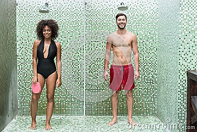 Cheerful youthful couple enjoying cleaning body in douche Stock Photo