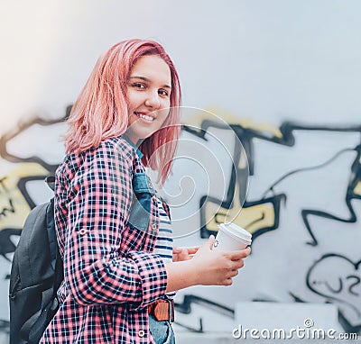Cheerfully smiling Beautiful modern young female teenager Portrait with extraordinary hairstyle color in checkered shirt holding Stock Photo