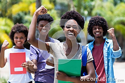 Cheering african female student with group of african american students Stock Photo